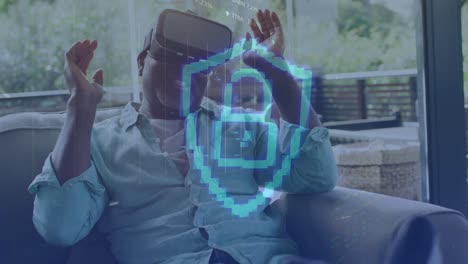 Animation-of-padlock-icon-and-data-processing-over-african-american-man-using-vr-headset