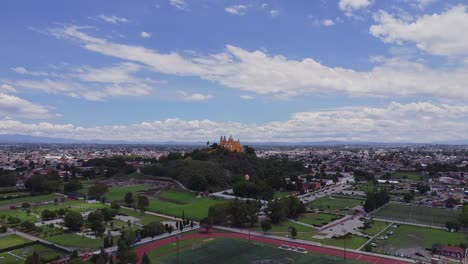 aerial drone forward moving shot over parish of the church in the magic town of cholula, puebla, mexico during day time