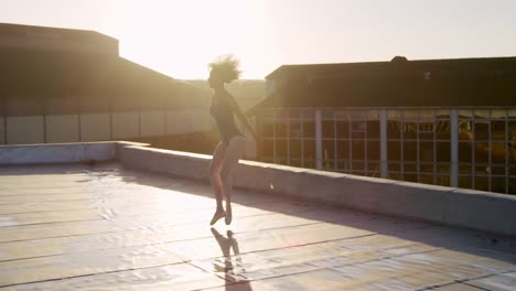 ballet dancer practicing on rooftop