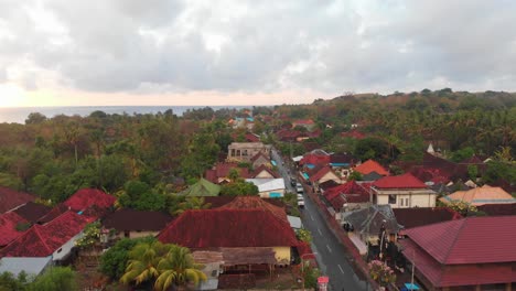 side panning shot of town at nusa penida indonesia during sunrise, aerial