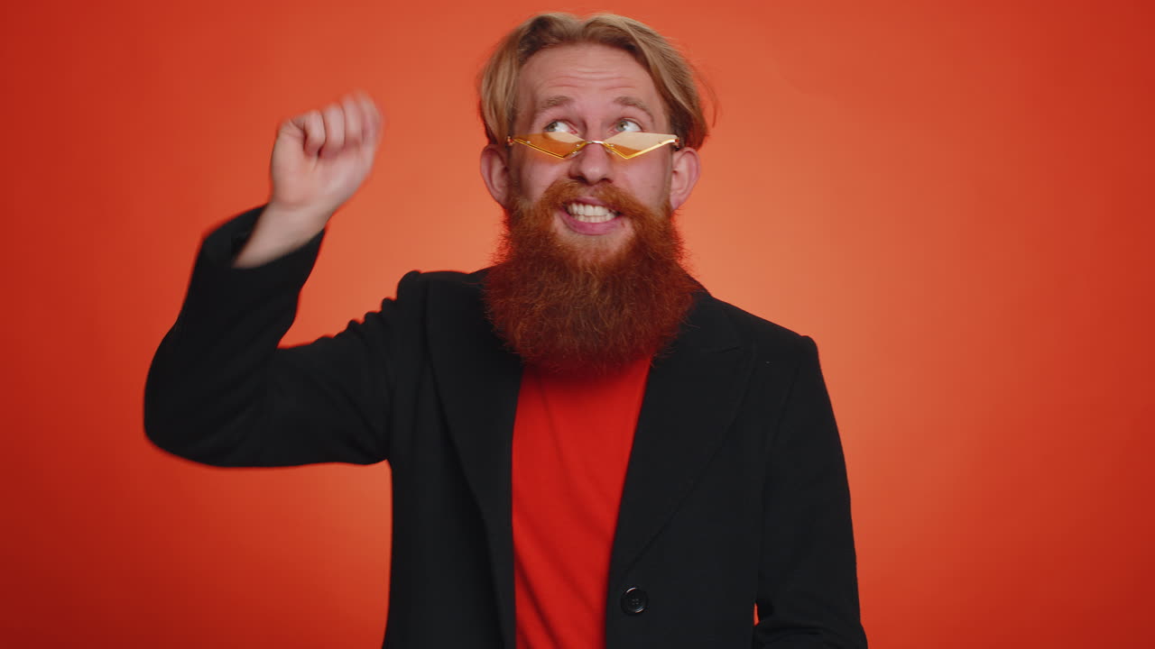 Man pointing down, saying to subscribe, gesturing ok and like, showing place for commercial info