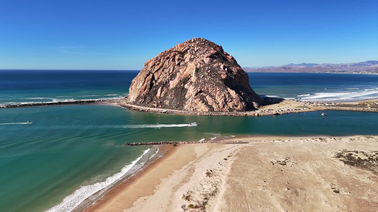 A smooth circular orbit that showcases the full scale and rugged texture of iconic Morro Rock