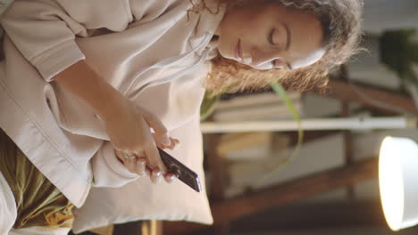 young woman relaxing on sofa with phone