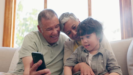 phone, grandparents and child on sofa for game