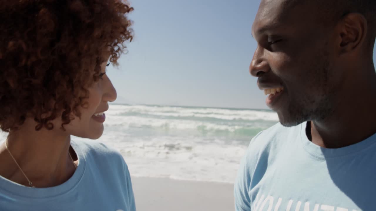 Volunteers interacting with each other on the beach 4k