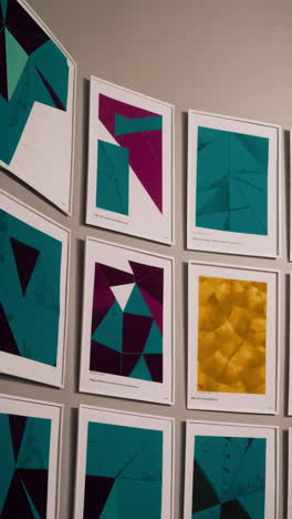 a collection of abstract geometric art prints displayed on a wall