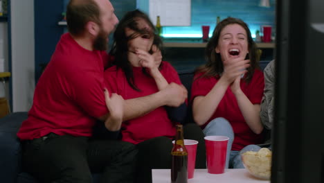 excited multi-ethnic fans having fun while watching football match