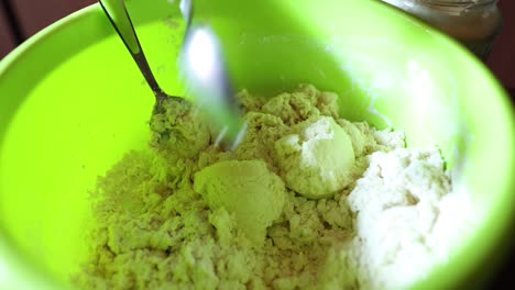 Baker-Puts-Ingredients-In-Making-Bread-Dough---close-up,-high-angle