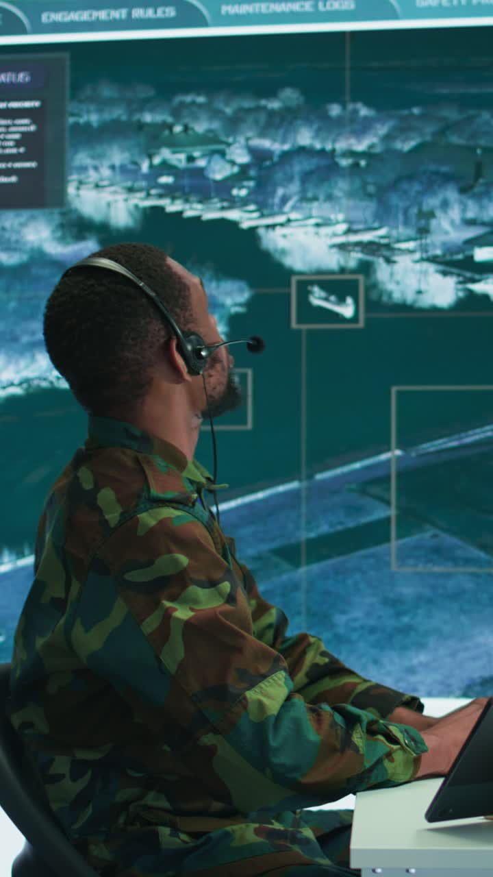 Vertical Video Soldiers in a modern command center analyze live data from cctv radar sources
