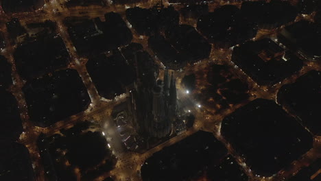 Night-aerial-shot-of-construction-site-of-famous-basilica-Sagrada-Familia-at-night.-Barcelona,-Spain