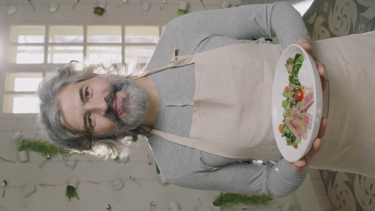 Man holding a plate of salad