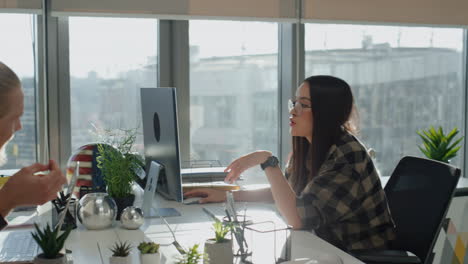 Two-people-brainstorming-at-office-close-up.-Diverse-colleagues-discussing