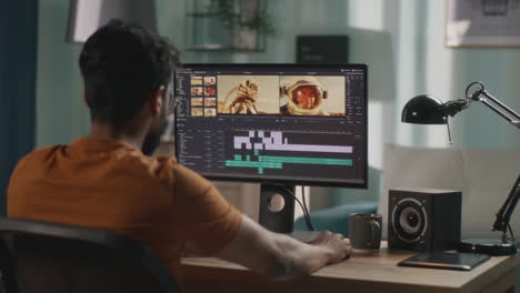 man editing video of astronauts