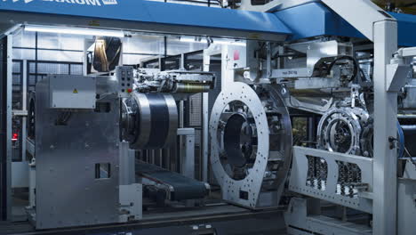 Tyre manufacturing factory storage with background worker in face mask working