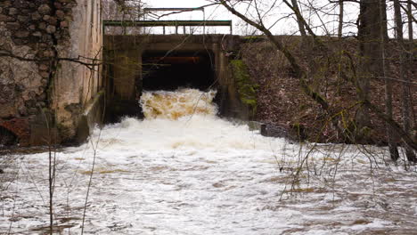 strong waterfall current flowing through sluice in slow motion, wide shot