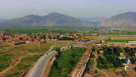 peshawar, pakistan, aerial view of busy mountain pass connecting the pak-afghan border through white range with valley of peshawar