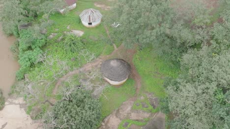 AERIAL---Small-huts-in-a-village,-Jos-Plateau,-Nigeria,-forward-shot