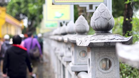 people walking along temple pathway in hanoi