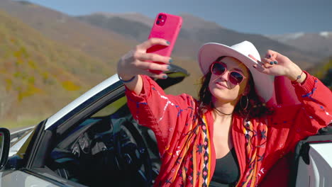 woman taking selfie in a convertible car