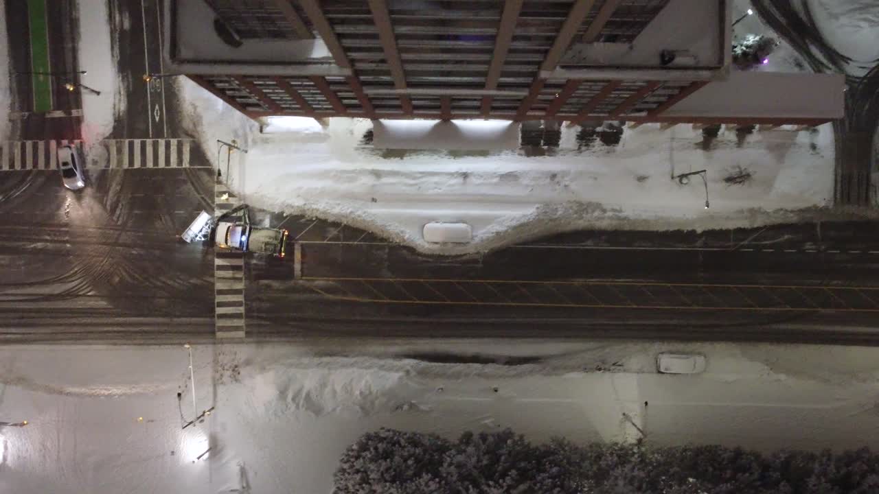 Snowplows clearing snowy Mississauga city streets during freezing winter night