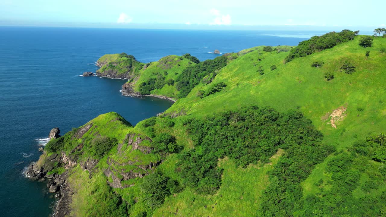 Sideview aerial of one of the Mariveles Five Fingers in Bataan, showcasing steep green cliffs dropping into deep blue waters with rugged coastline and dramatic natural beauty
