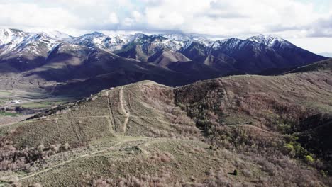 Central-Utah-Snowcapped-Mountains-with-a-Cloudy-Sky-Aerial-Drone-4K