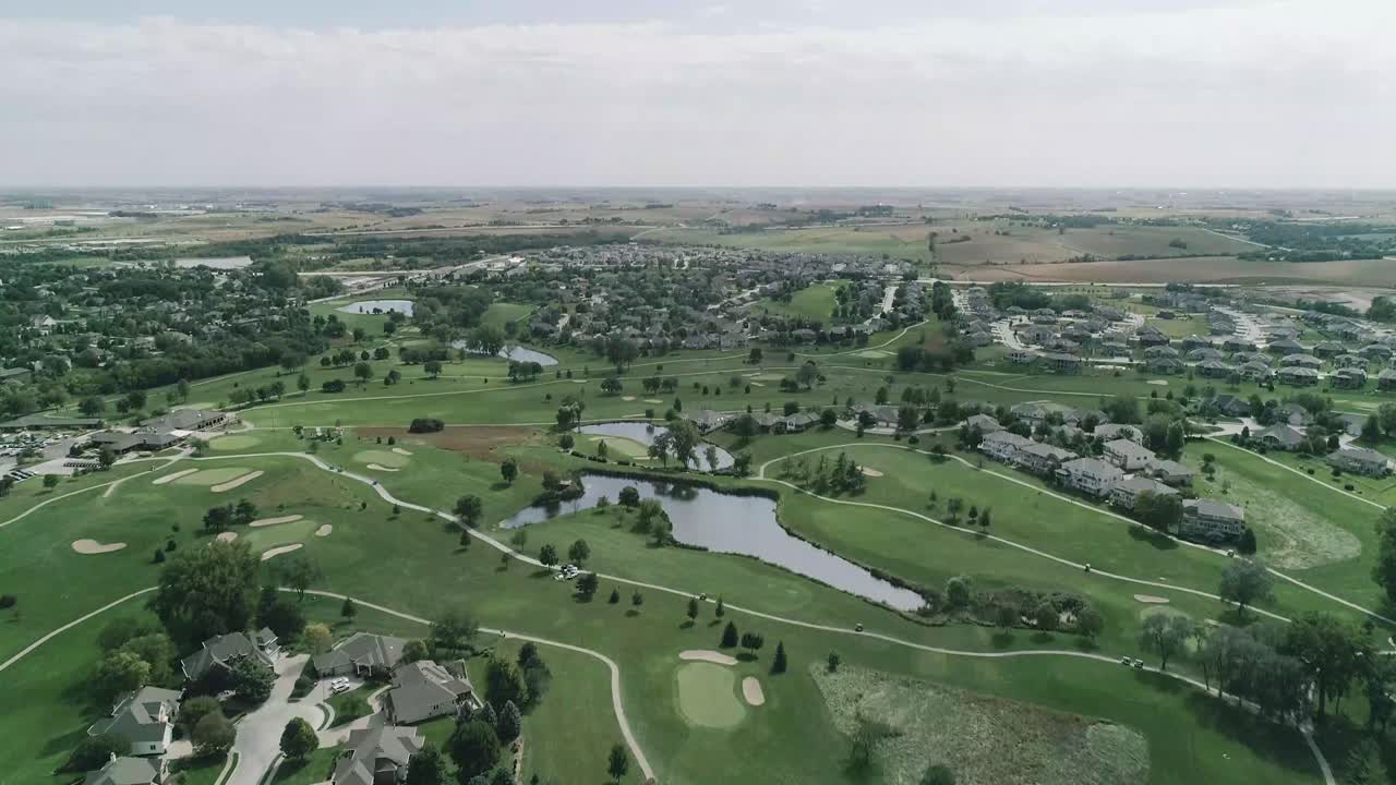 High Angle drone shot over golf course community