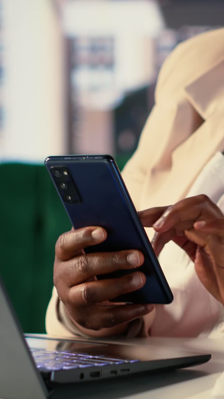 Close Up of Person's Hands Using Smartphone and Laptop