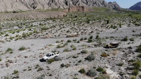 Aerial-rotating-drone-shot-of-car-driving-in-the-mountain-road-in-the-morning-time