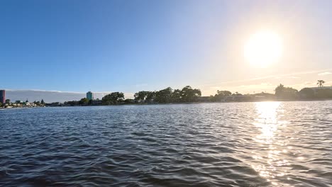 boat cruising under the gold coast sunset