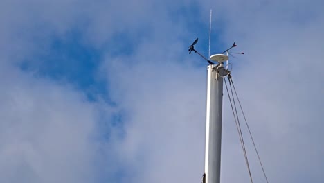 A-shot-of-an-antenna-with-a-blue-sky-and-cloudy-backdrop