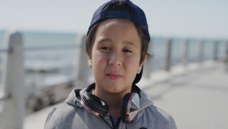 portrait little boy looking calm pensive enjoying summer vacation on warm ocean seaside slow motion