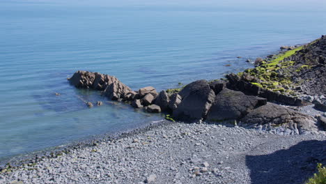 extra wide shot of exposed sedimentary rock at low tide at new quay, wales