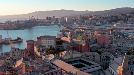 sunset aerial pullback view of historic portoria district, porto antico, genova