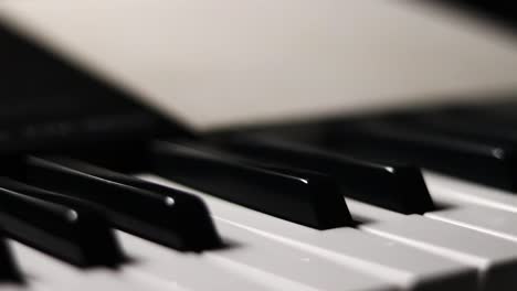 close-up macro pan of black and white piano keys