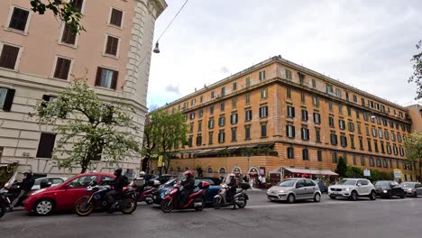 traffic and pedestrians near a historic building