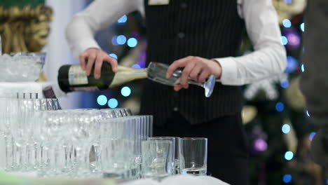 waiter pouring glasses of champagne