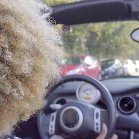 young woman driving a cabriolet