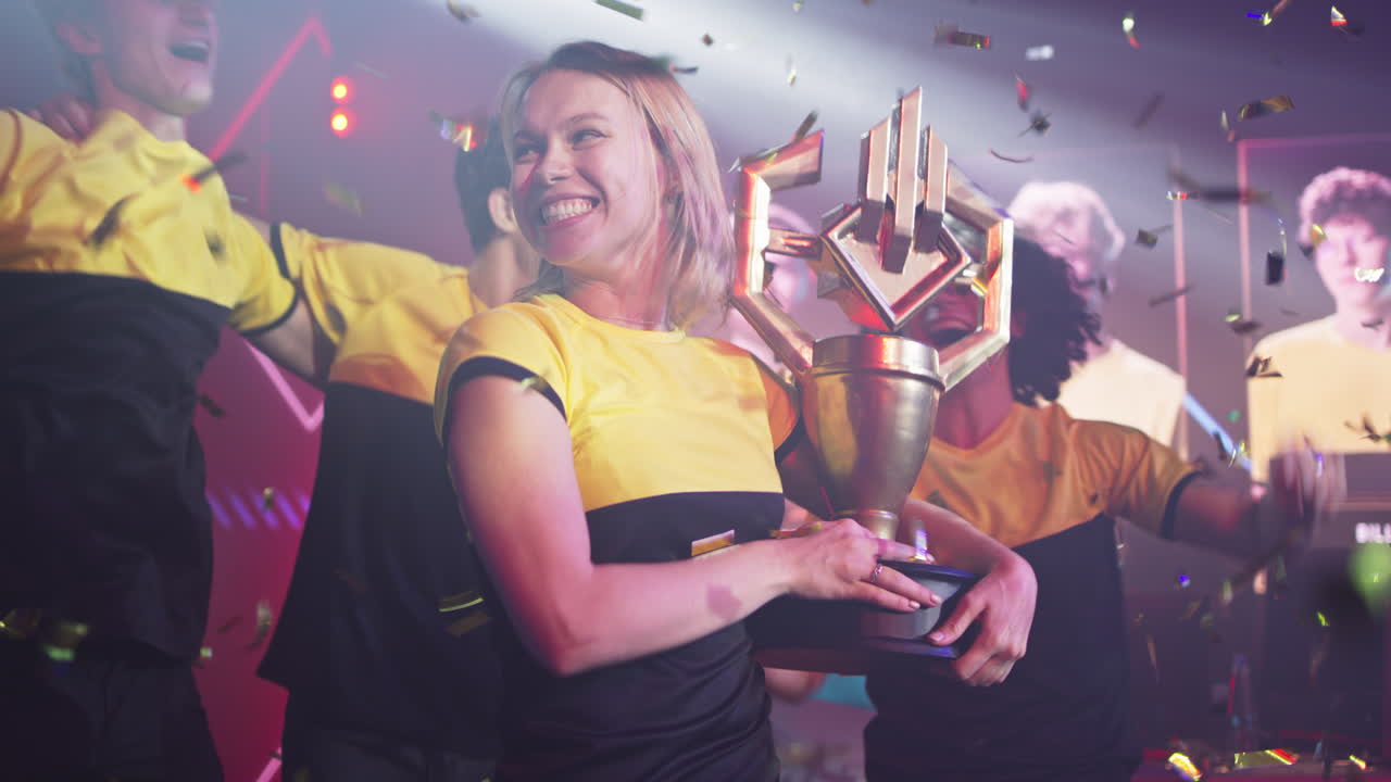 Esports Team Celebrates Championship Victory with Trophy and Confetti