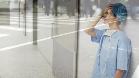 Animation-of-a-doctor-standing-in-a-hospital-hallway-over-people-crossing-the-street.