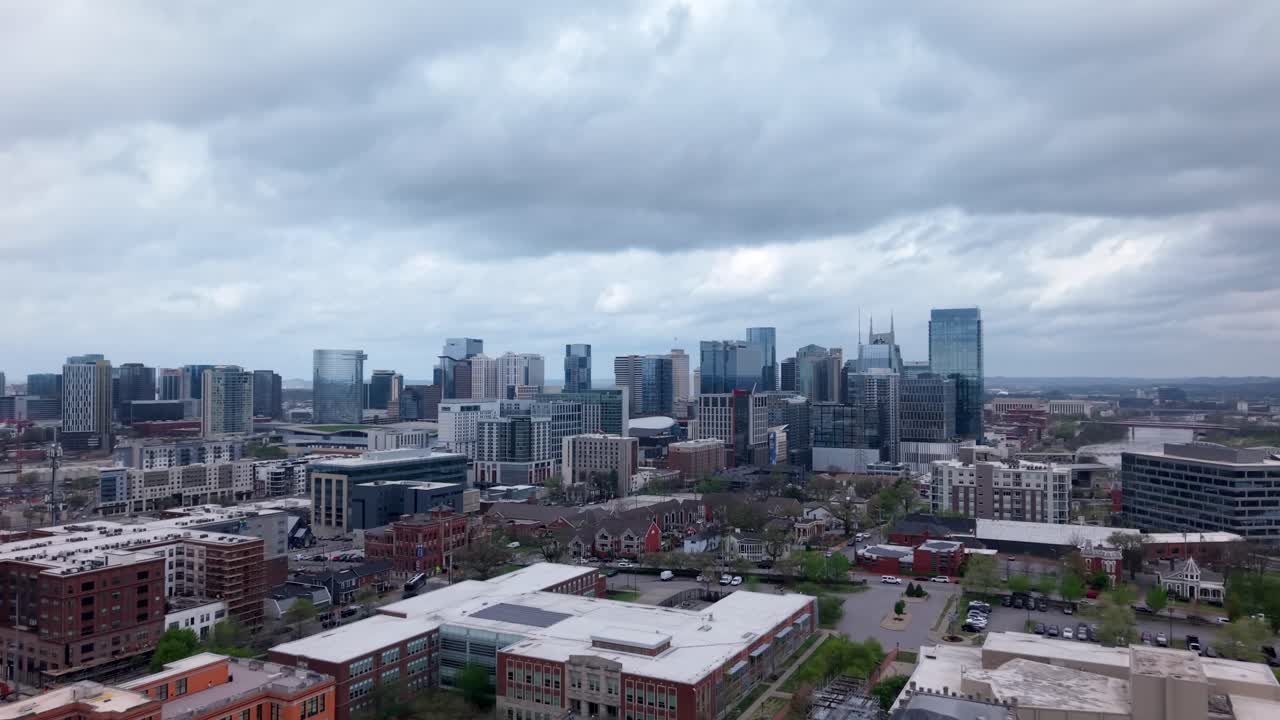 Downtown Nashville City Skyline With Dramatic Clouds In The Sky Above. Aerial Flyover
