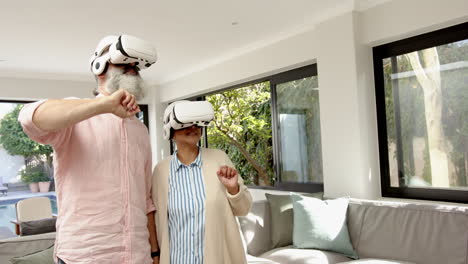 senior couple using vr headsets, exploring virtual reality in living room, copy space