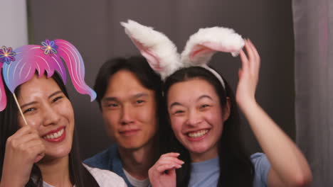 Group-Of-Young-Friends-Having-Fun-Posing-In-Photo-Booth-With-Props-Shot-In-Real-Time-1