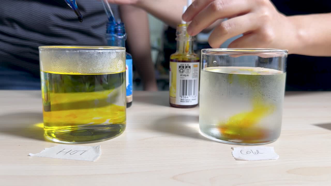 Food coloring spreads in hot and cold water glasses, demonstrating temperature effects on diffusion