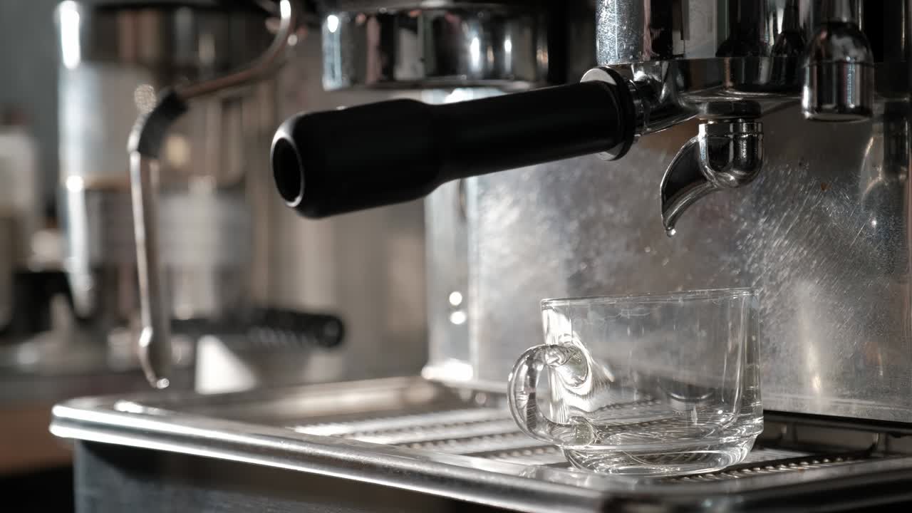 Barista preparing coffee machine and brewing espresso coffee at cafe