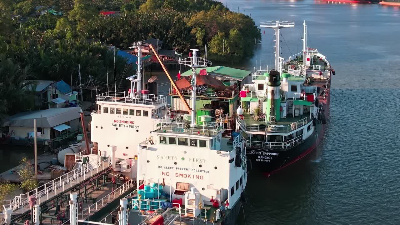 Boats dock at the port in Bangkok with the city skyline in the background