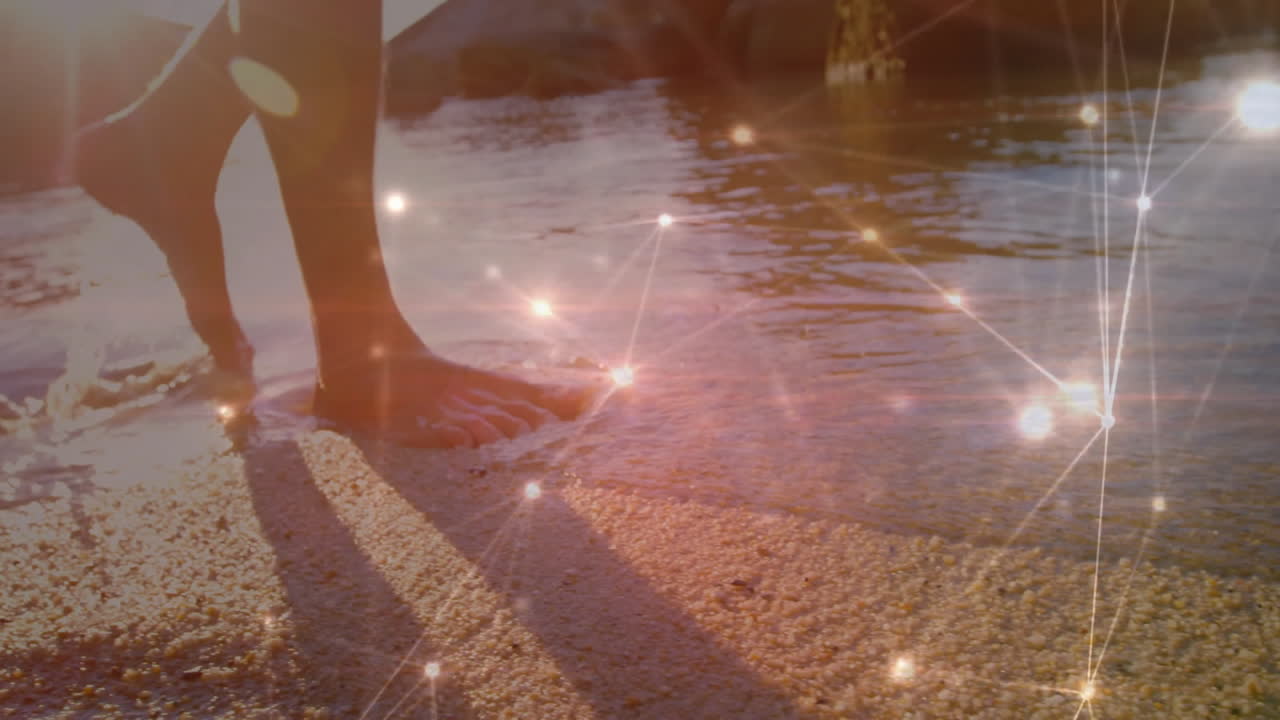 Bare feet walking on beach with glowing network connections animation