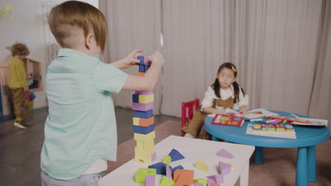 little boy playing with foam building blocks in a montessori school