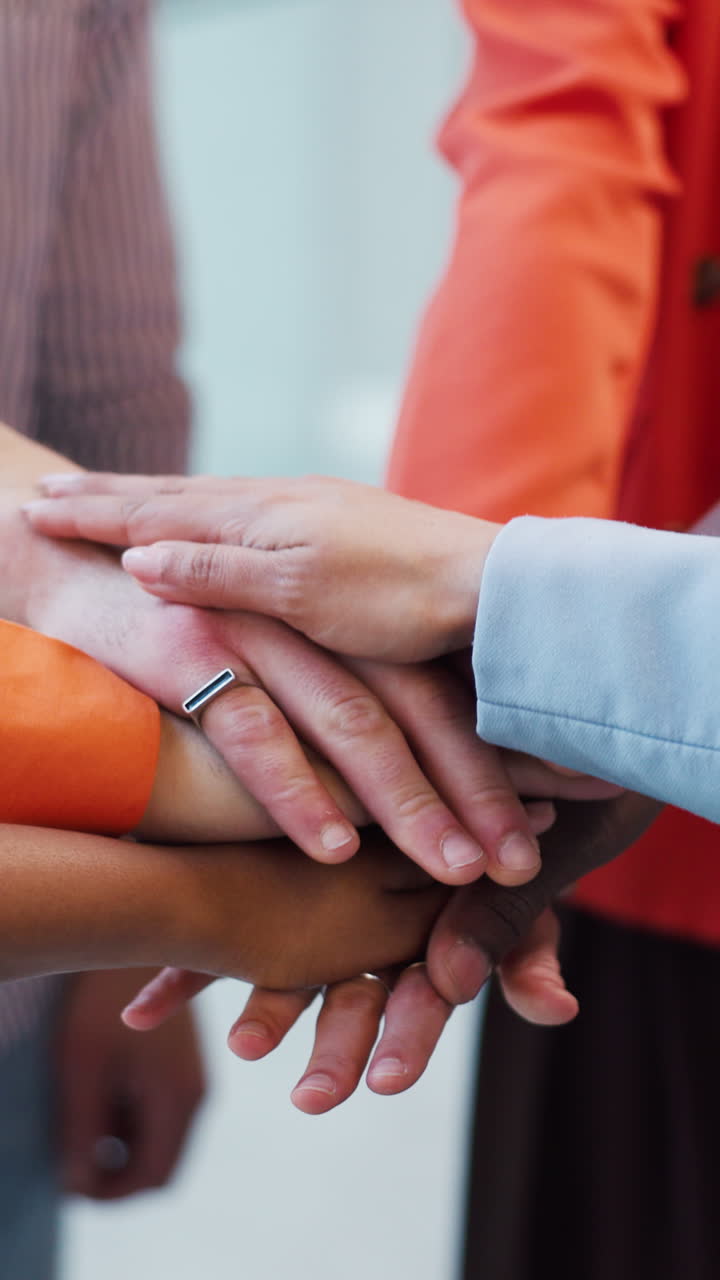 Diverse Group of People Stacking Hands Together for Teamwork