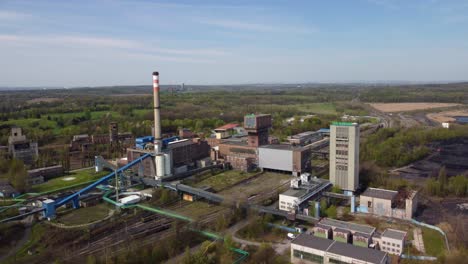 Old-coal-mine-elevator-and-piles-of-slag-behind-in-Karvina-on-a-sunny-day